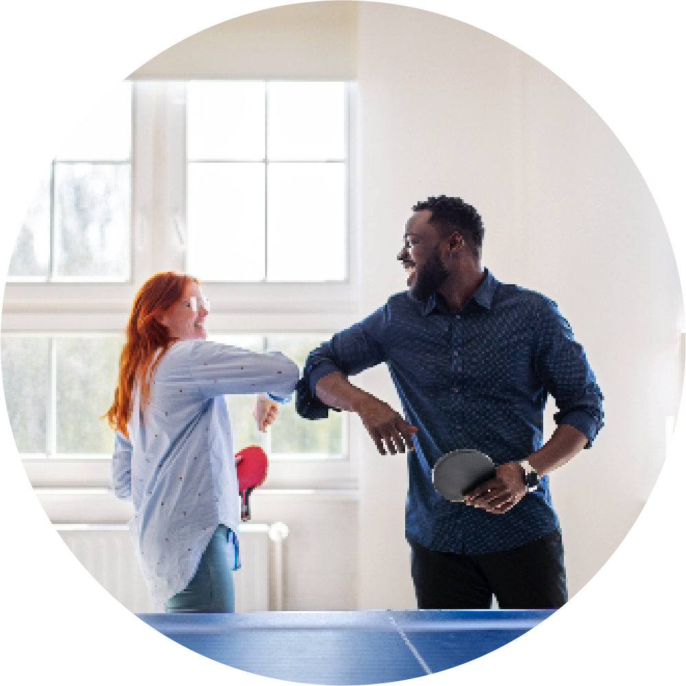 two employees playing ping pong