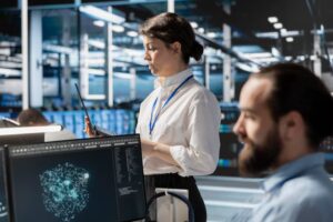 IT professional monitoring an ETL workflow dashboard in a healthcare environment, ensuring accurate and timely data processing.