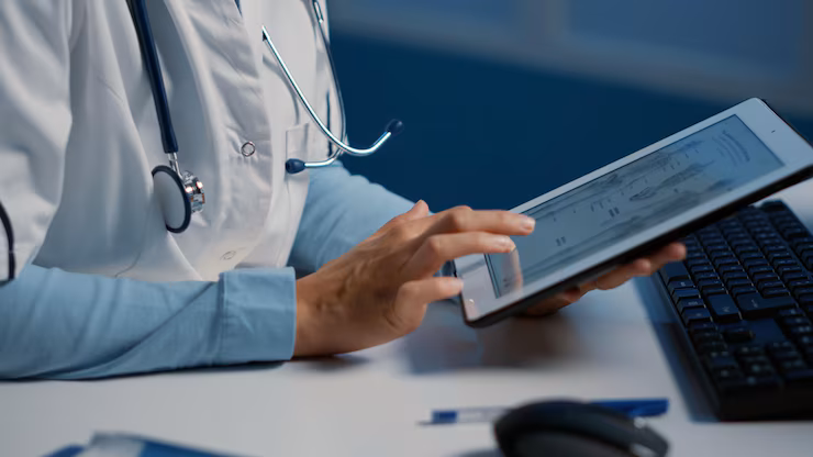Medical professional analyzing real-time analytics to track patient progress and adjust treatment plans accordingly.