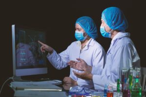 Clinician reviewing AI-analyzed medical images with annotations highlighting potential abnormalities for faster diagnosis.