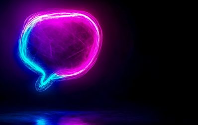 Glowing neon speech bubble reflecting on dark surface Vibrant neon speech bubble, illuminated in pink and blue hues, hovers above a dark reflective surface, creating a striking visual against the black backdrop